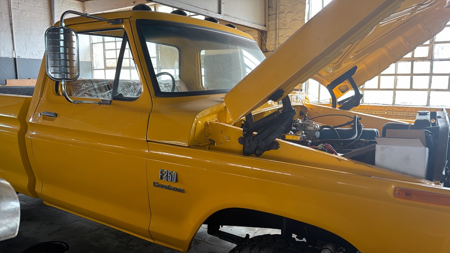 Yellow Ford F250 project vehicle in the workshop