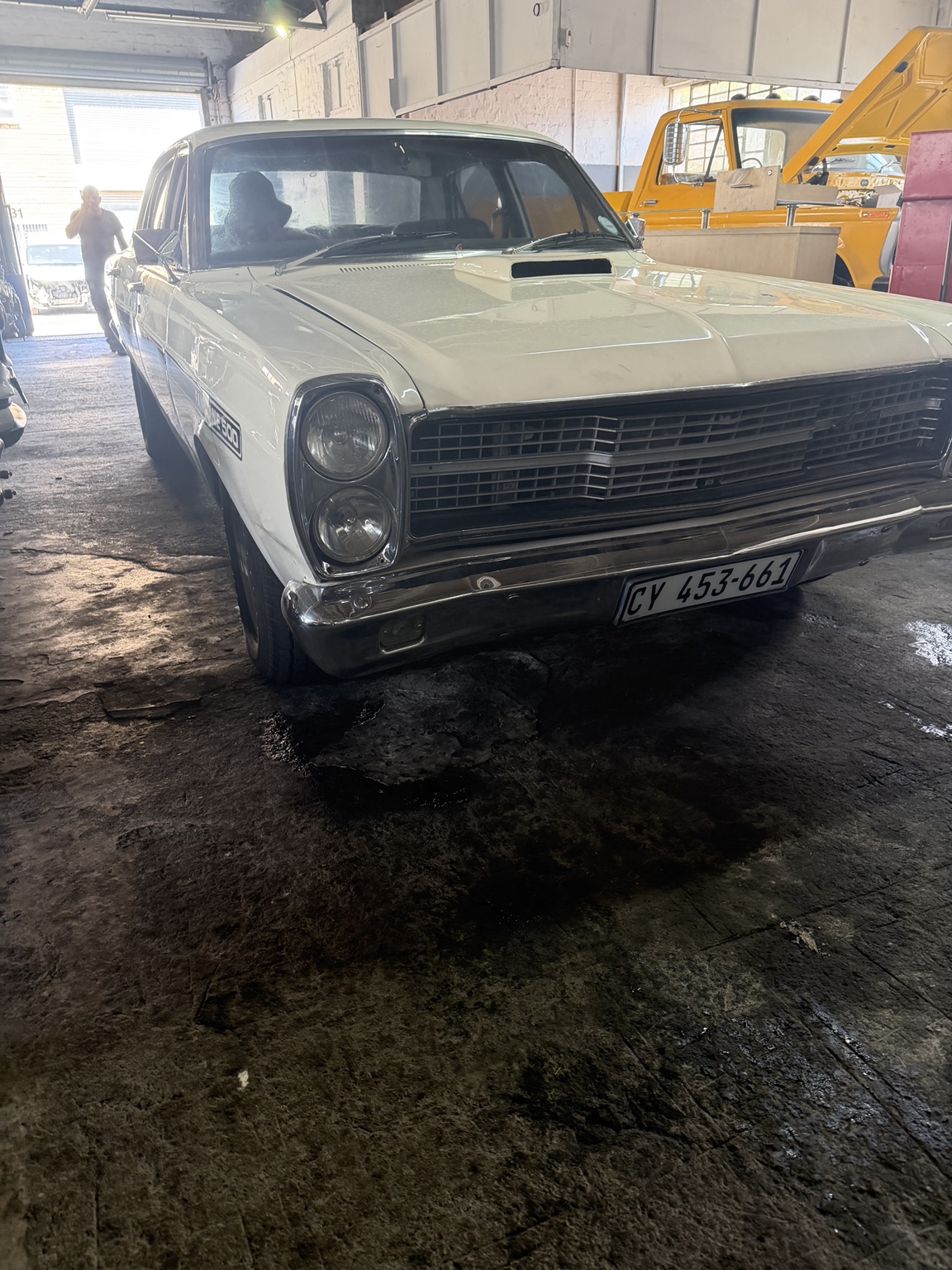 White classic car inside the workshop